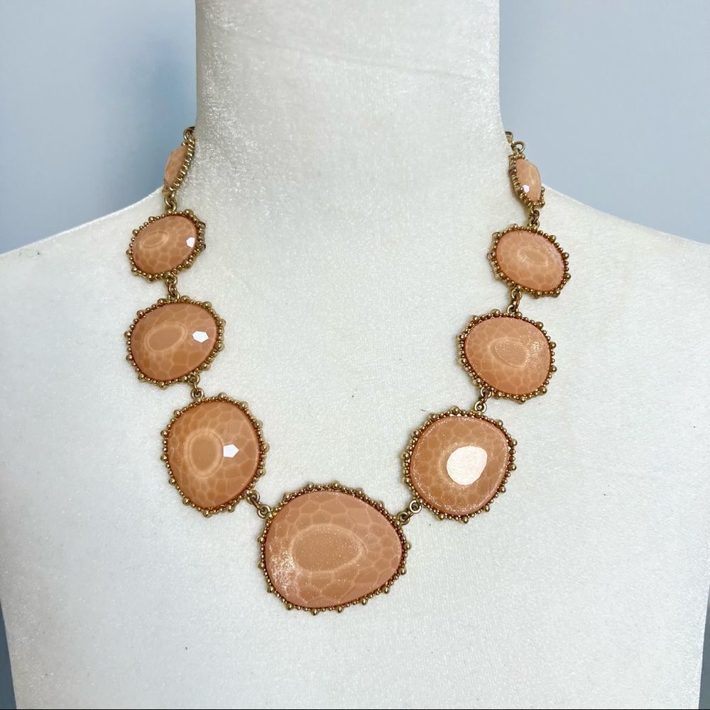 Faceted gem statement necklace on a gold tone chain